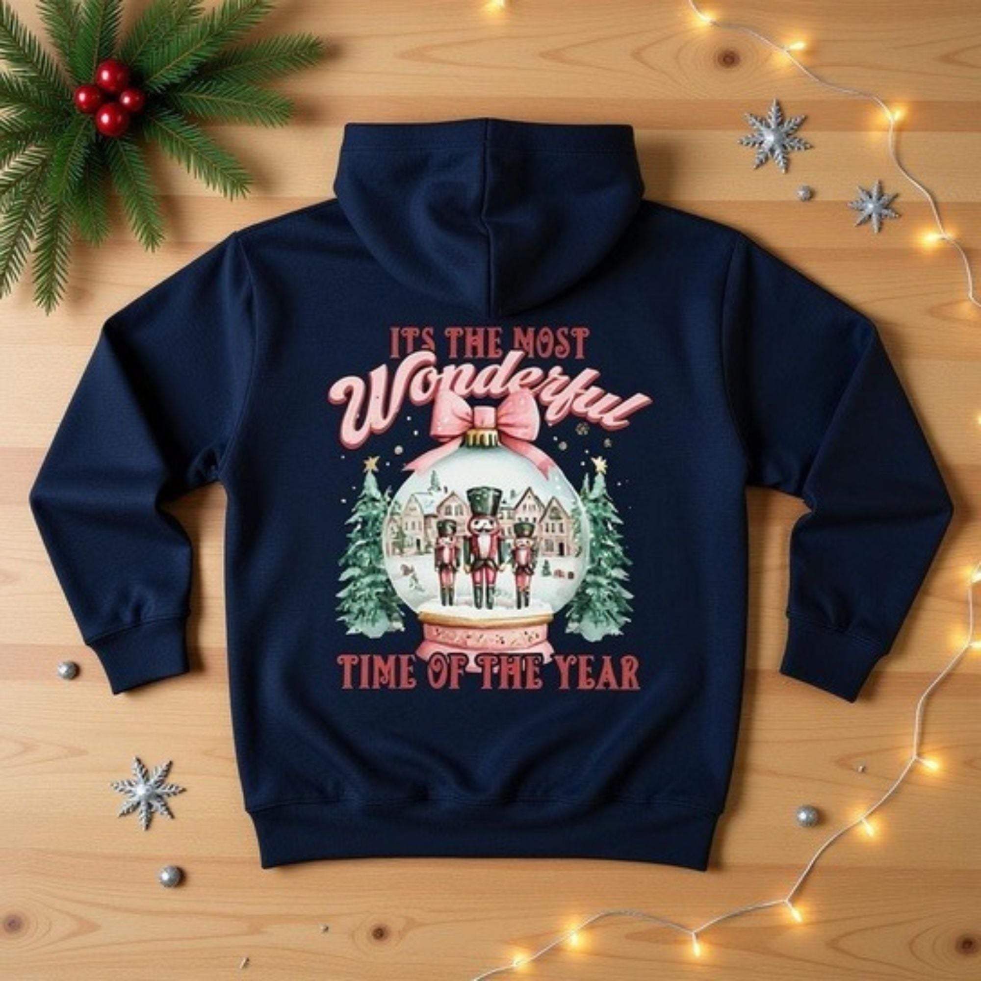 Navy fleece hoodie with festive snow globe and nutcracker design, cozy winter holiday sweatshirt