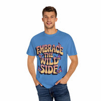 Blue garment-dyed T-shirt with "Embrace the Wild Side" print featuring butterflies worn by smiling man