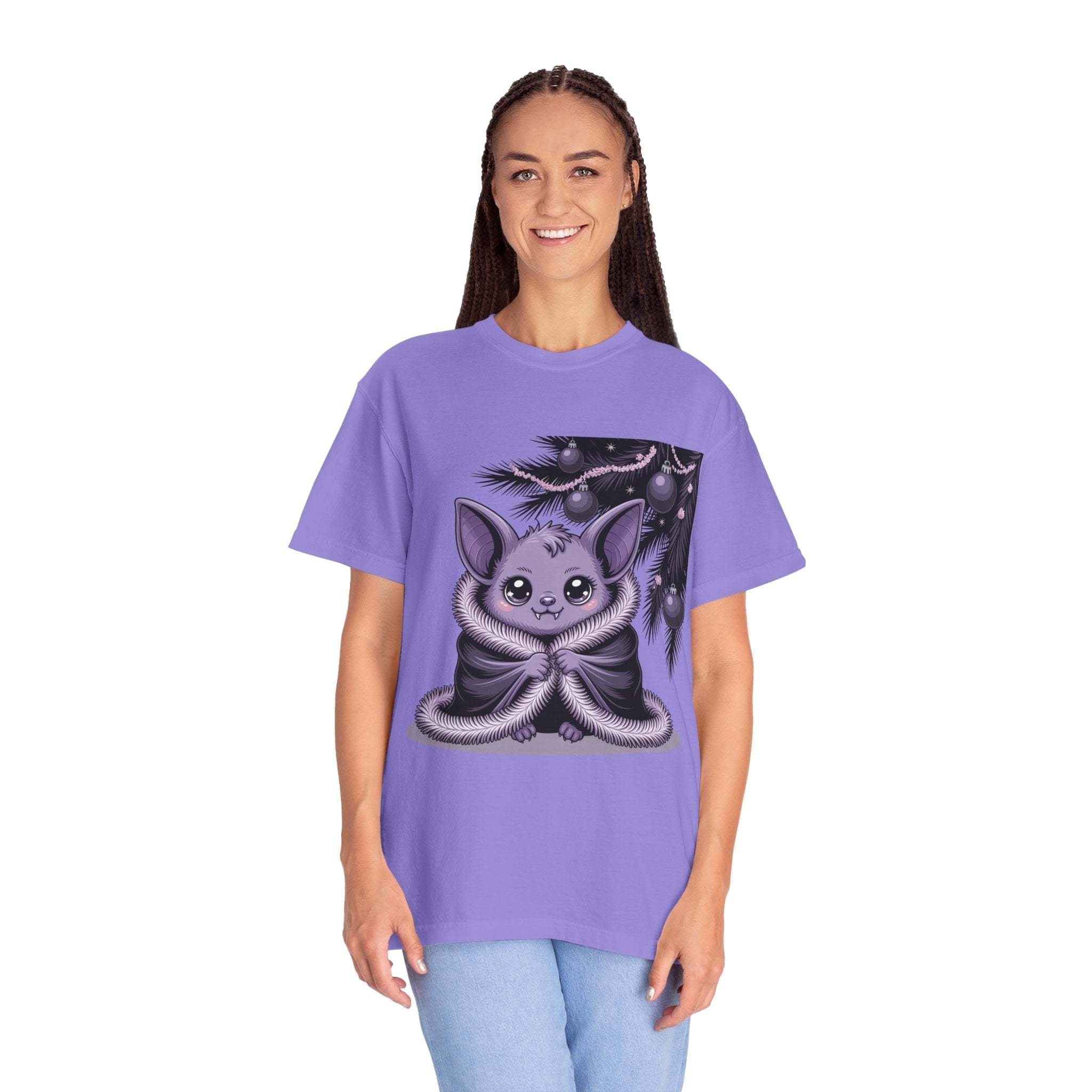 Person wearing a purple t-shirt with a cute creature design on a white background