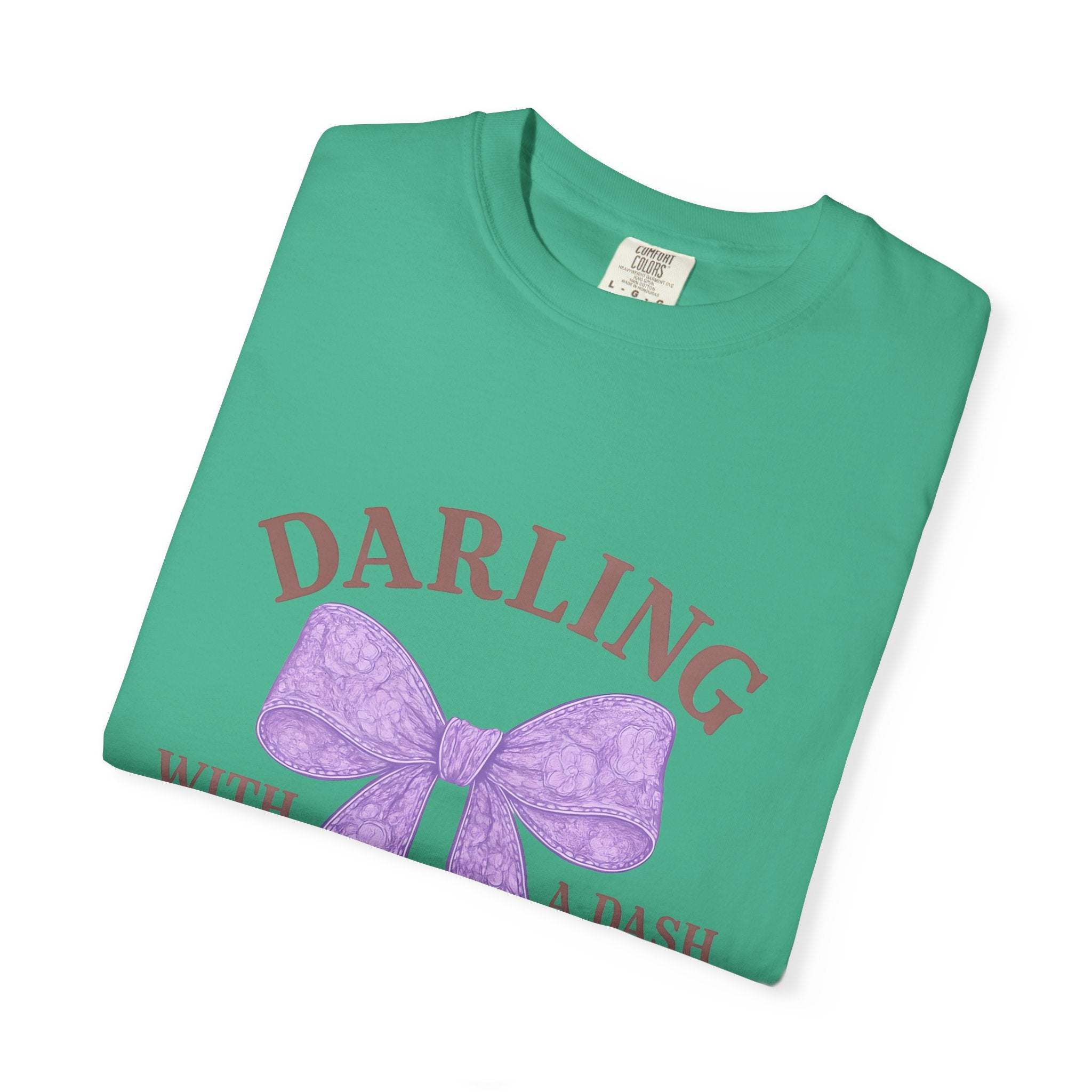 Green t-shirt with purple bow and text on a white background