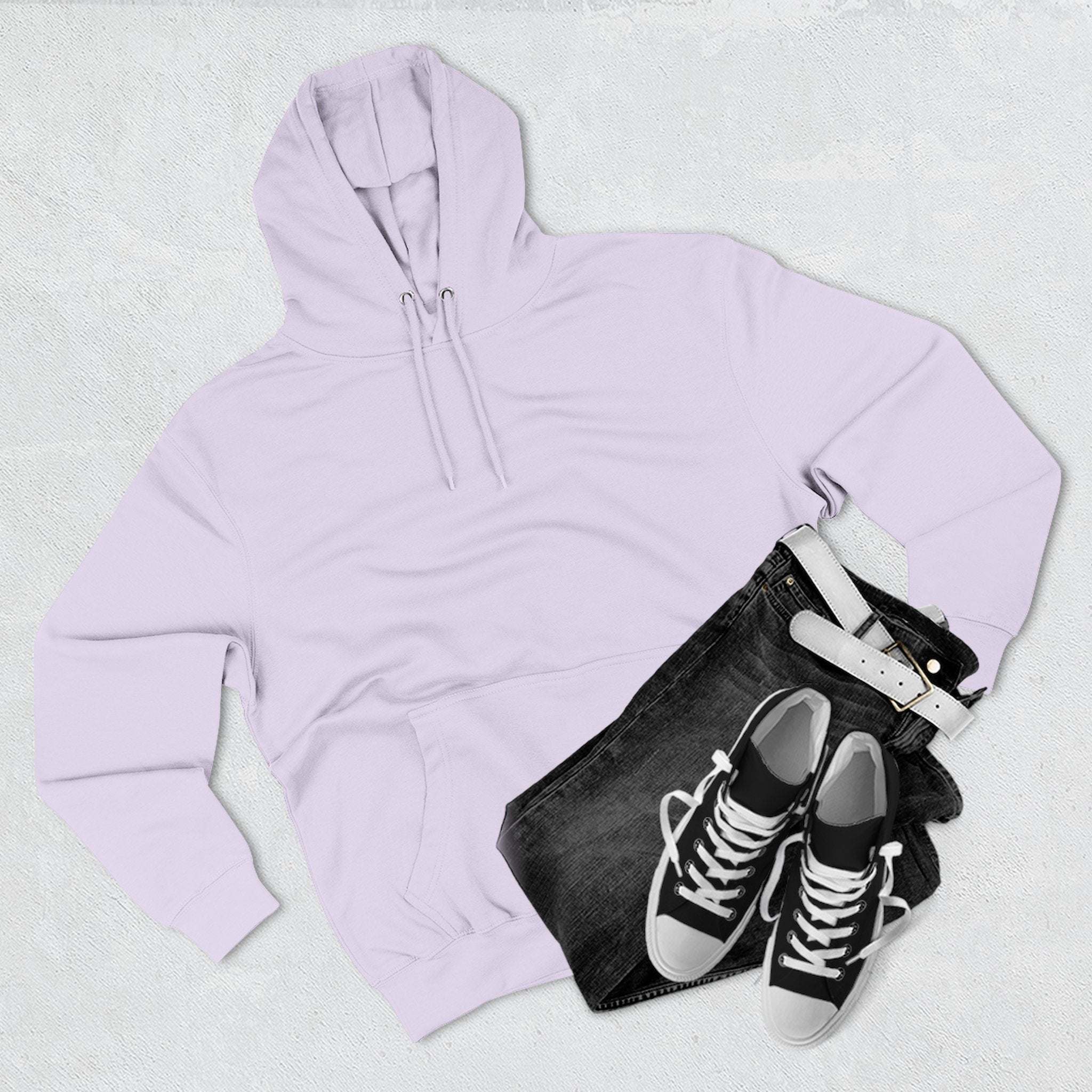 Light purple fleece hoodie with adjustable hood and kangaroo pocket, paired with black jeans and black sneakers.