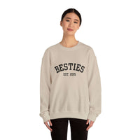 Person wearing a beige sweatshirt with 'BESTIES EST. 2025' text on a white background