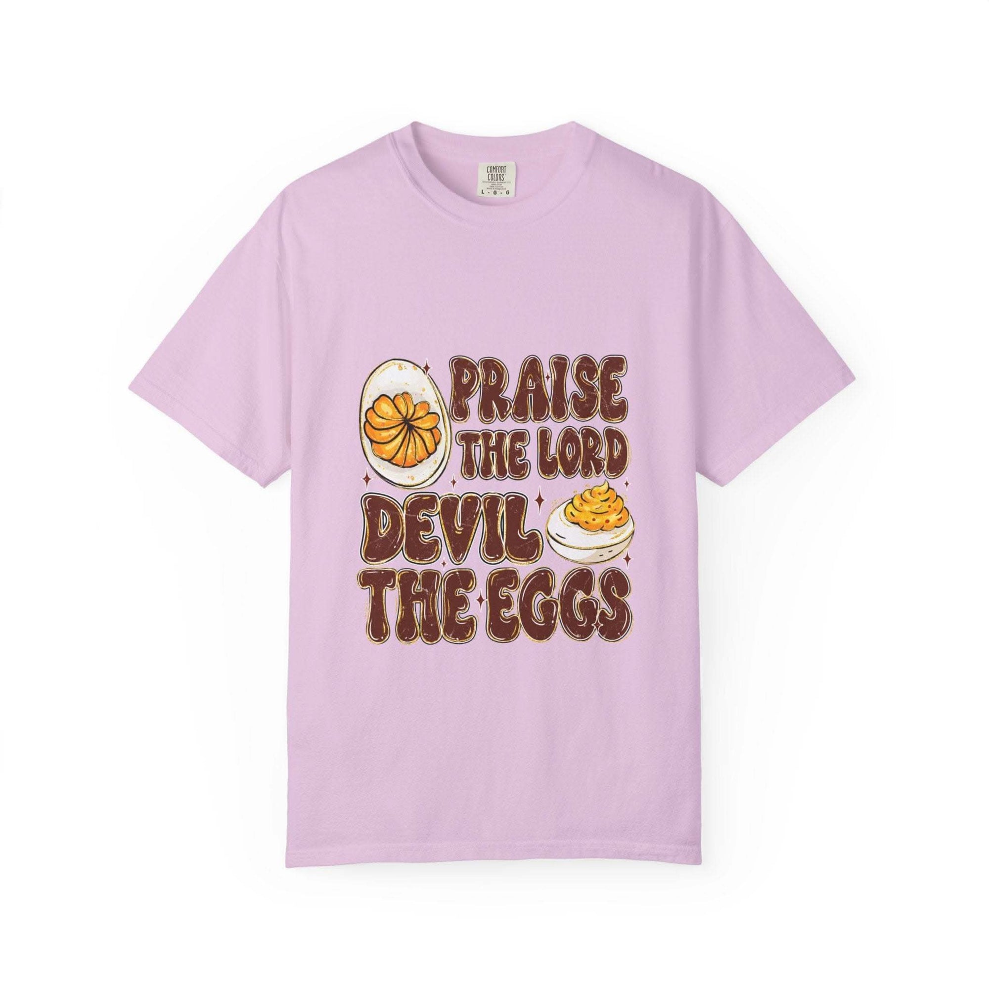 White cotton t-shirt featuring 'Praise the Lord, Devil the Eggs' design, perfect for Easter and Christian apparel.