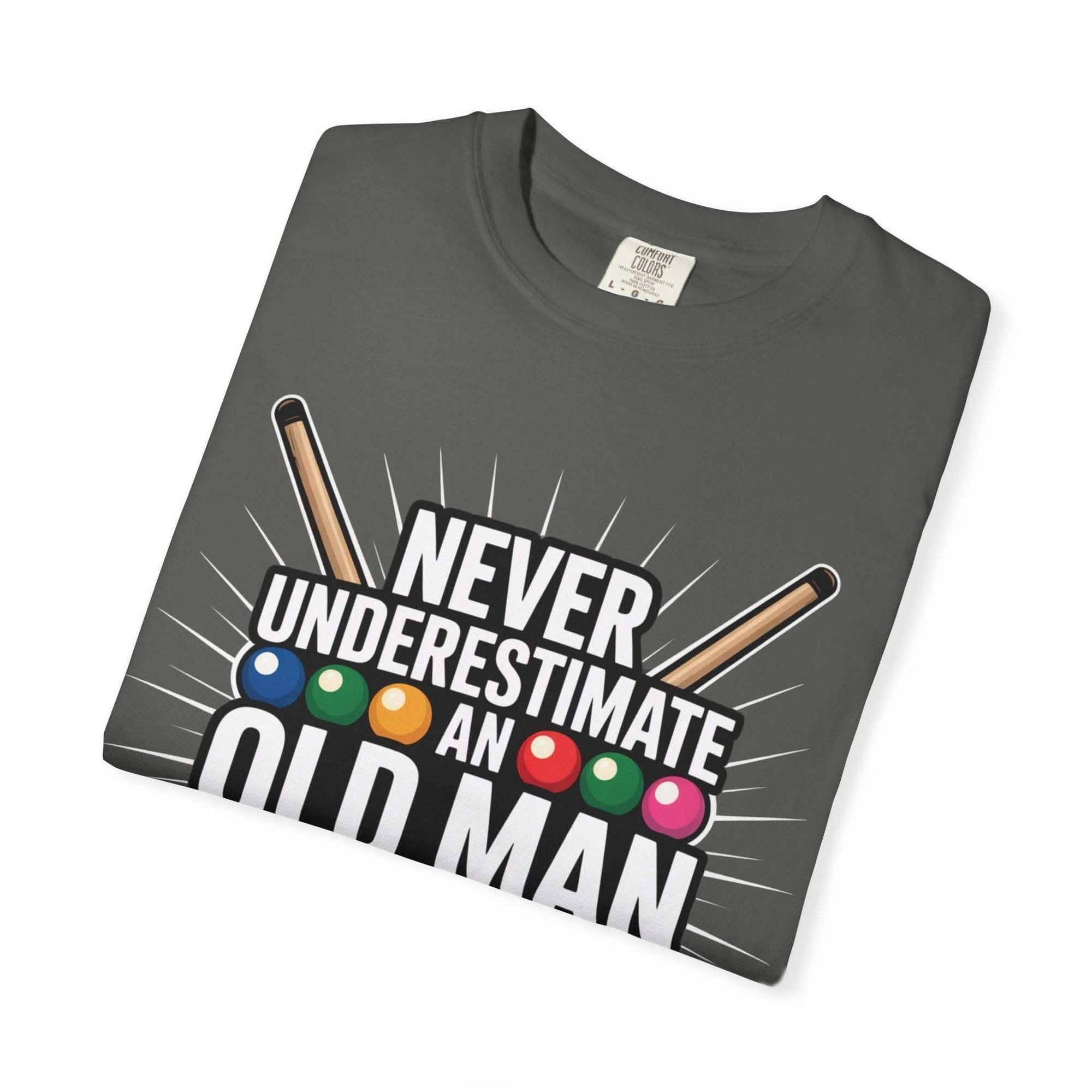 Never Underestimate An Old Man pool cue billiards themed t-shirt folded on grey background