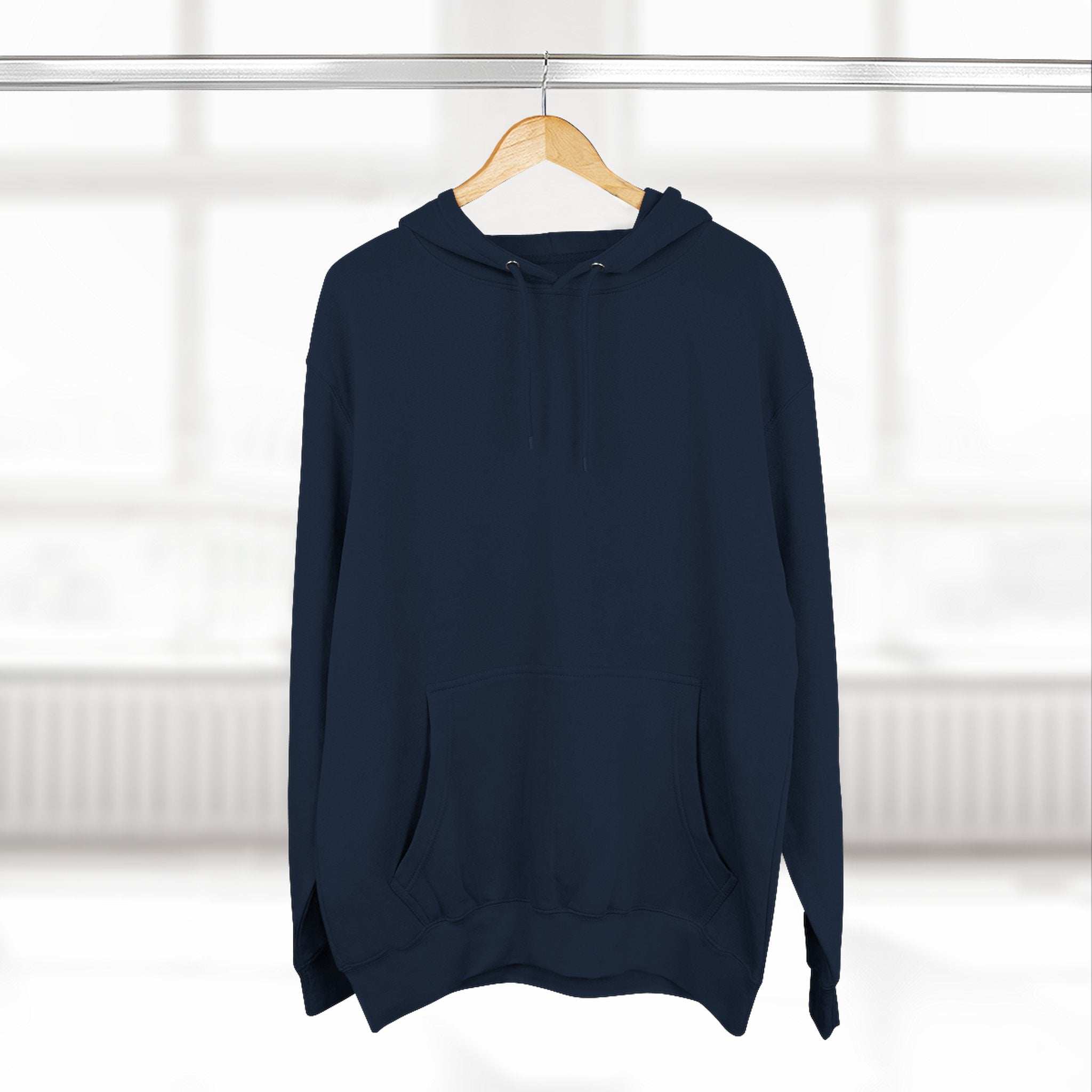 Navy blue fleece hoodie with adjustable hood and kangaroo pocket hanging on wooden hanger