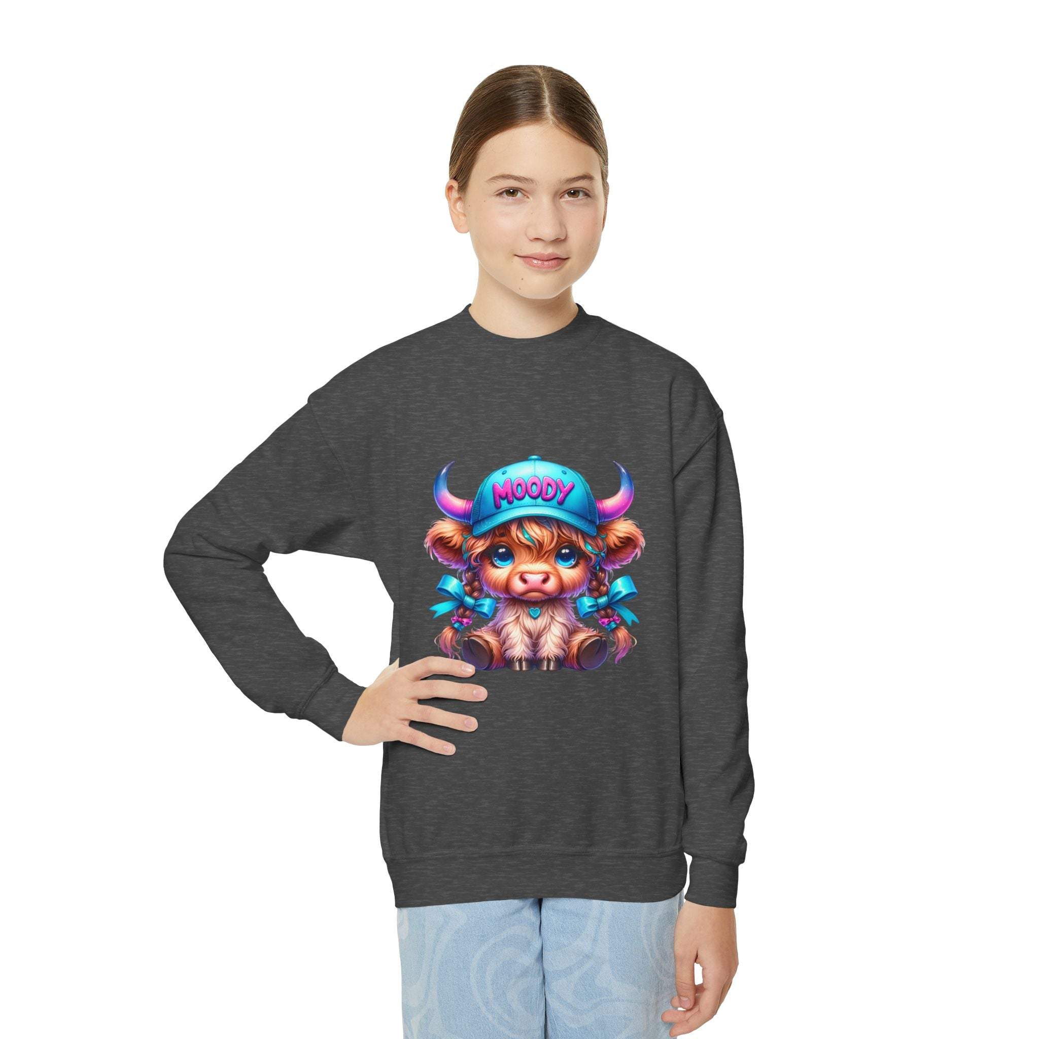 Youth wearing Moody Girl Highland Cow sweatshirt with playful cow graphic, cozy fit, and ribbed collar