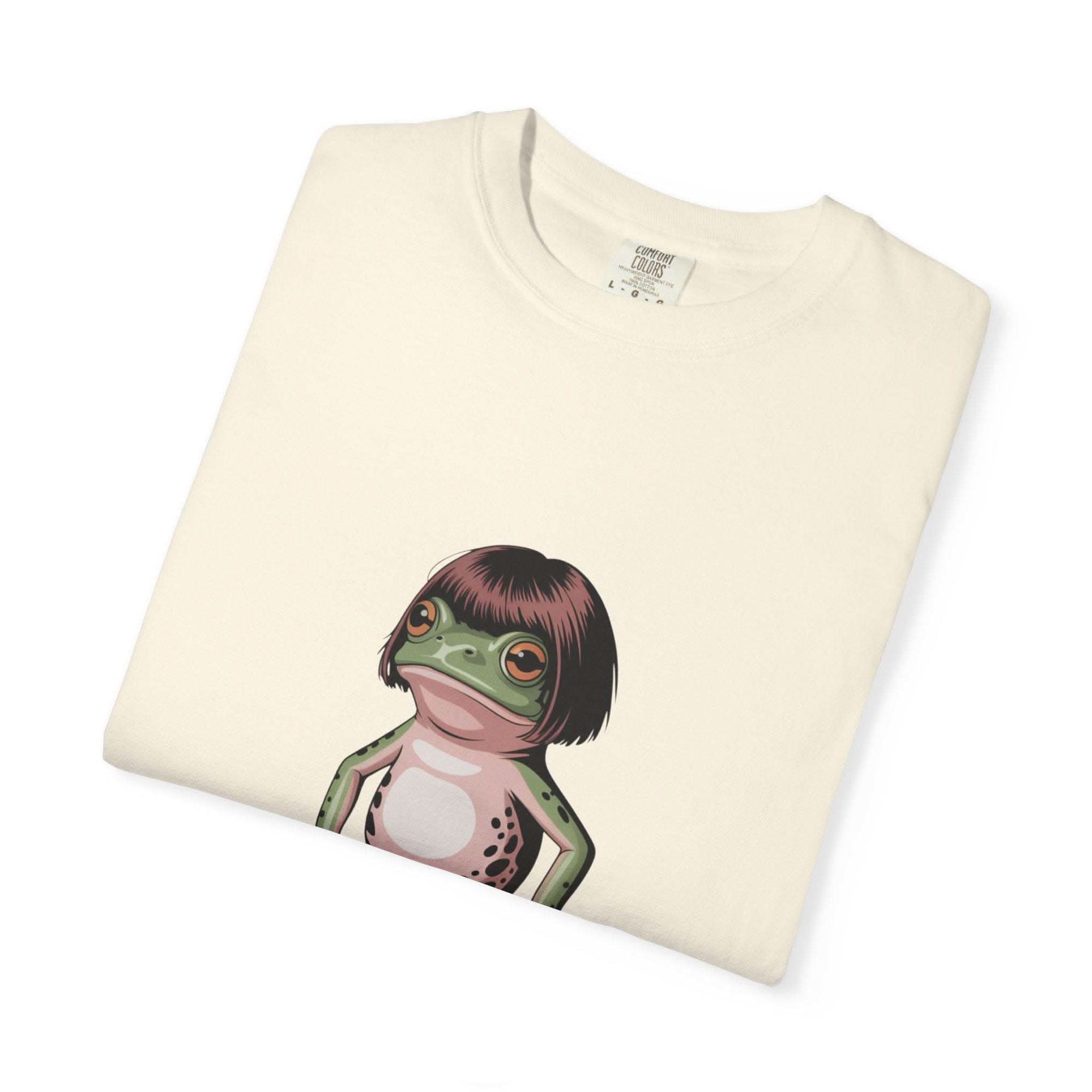 Cream t-shirt with a frog illustration featuring a bob haircut meme design