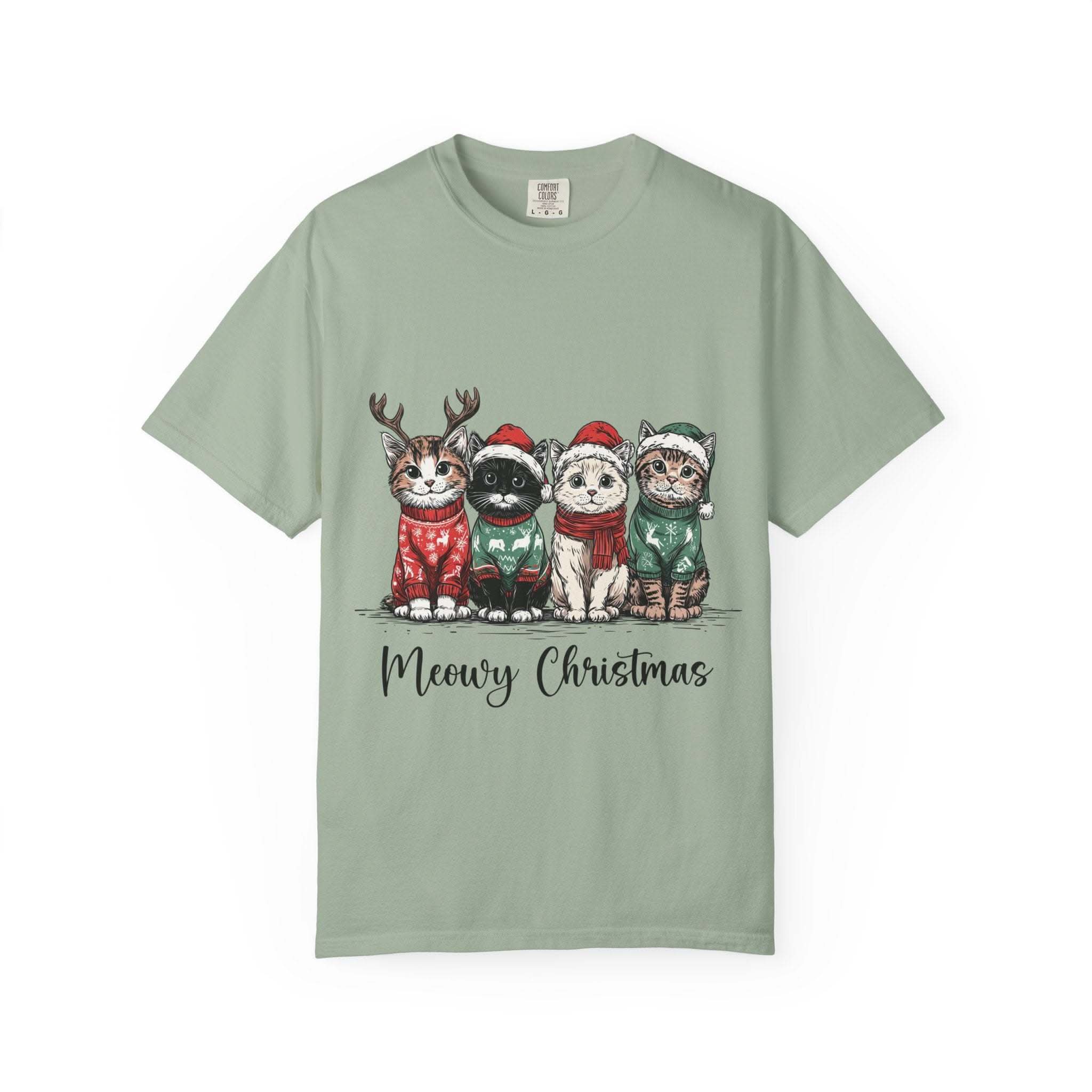 Cat Lover T-shirt with Meowy Christmas design featuring cats in holiday sweaters on green fabric