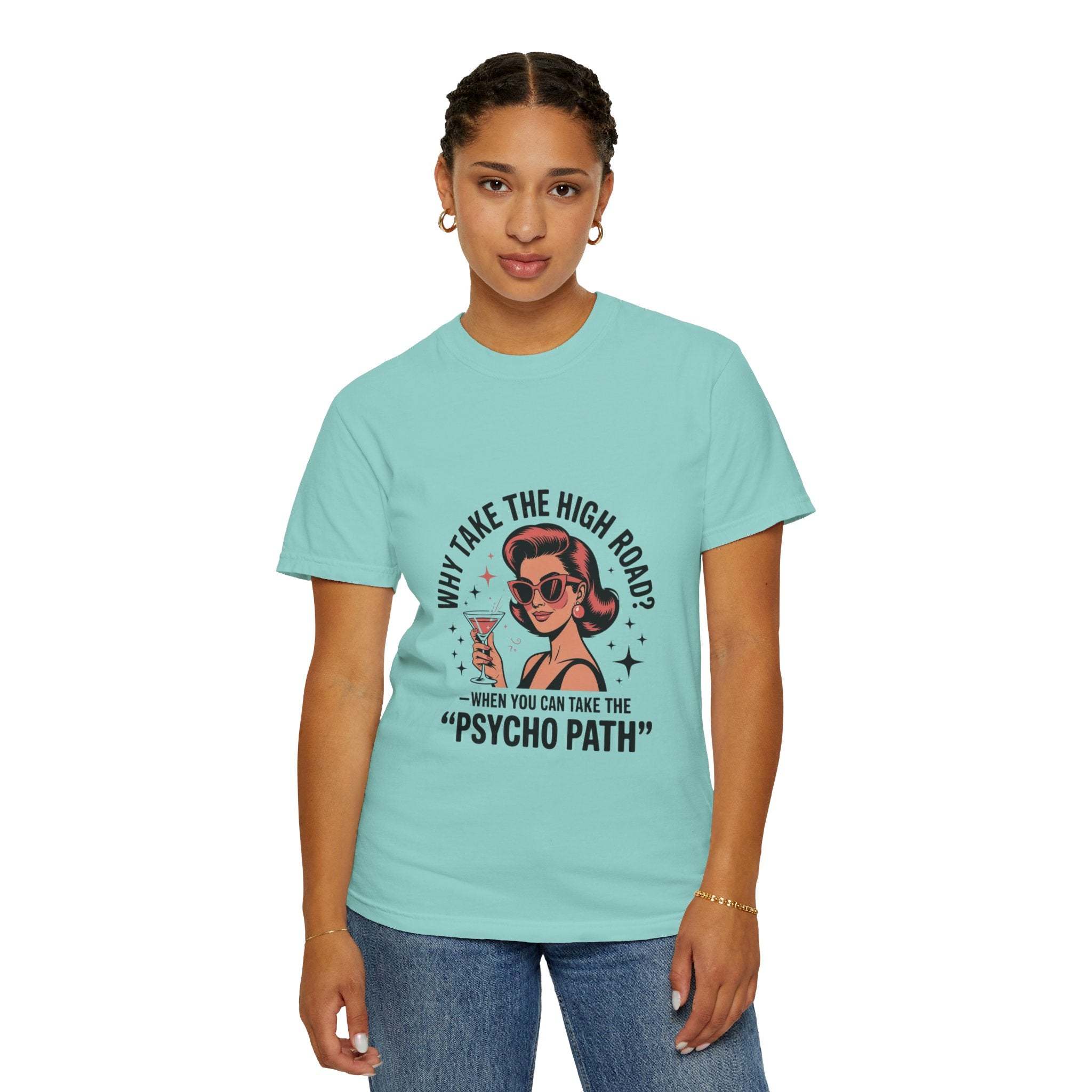 Woman wearing light blue garment-dyed T-shirt with retro "Why Take The High Road? Psycho Path" graphic design