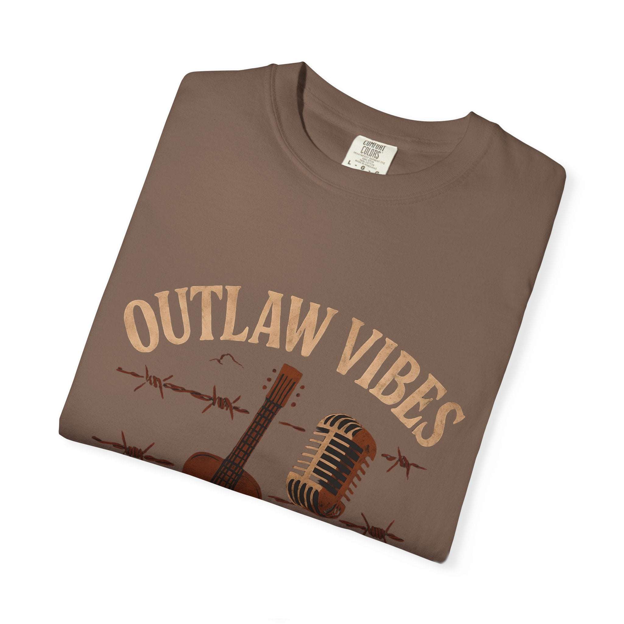 Folded brown t-shirt with 'Outlaw Vibes' text and graphics on a white background