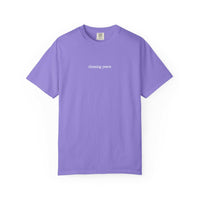 Purple t-shirt with 'chasing peace' text on a white background