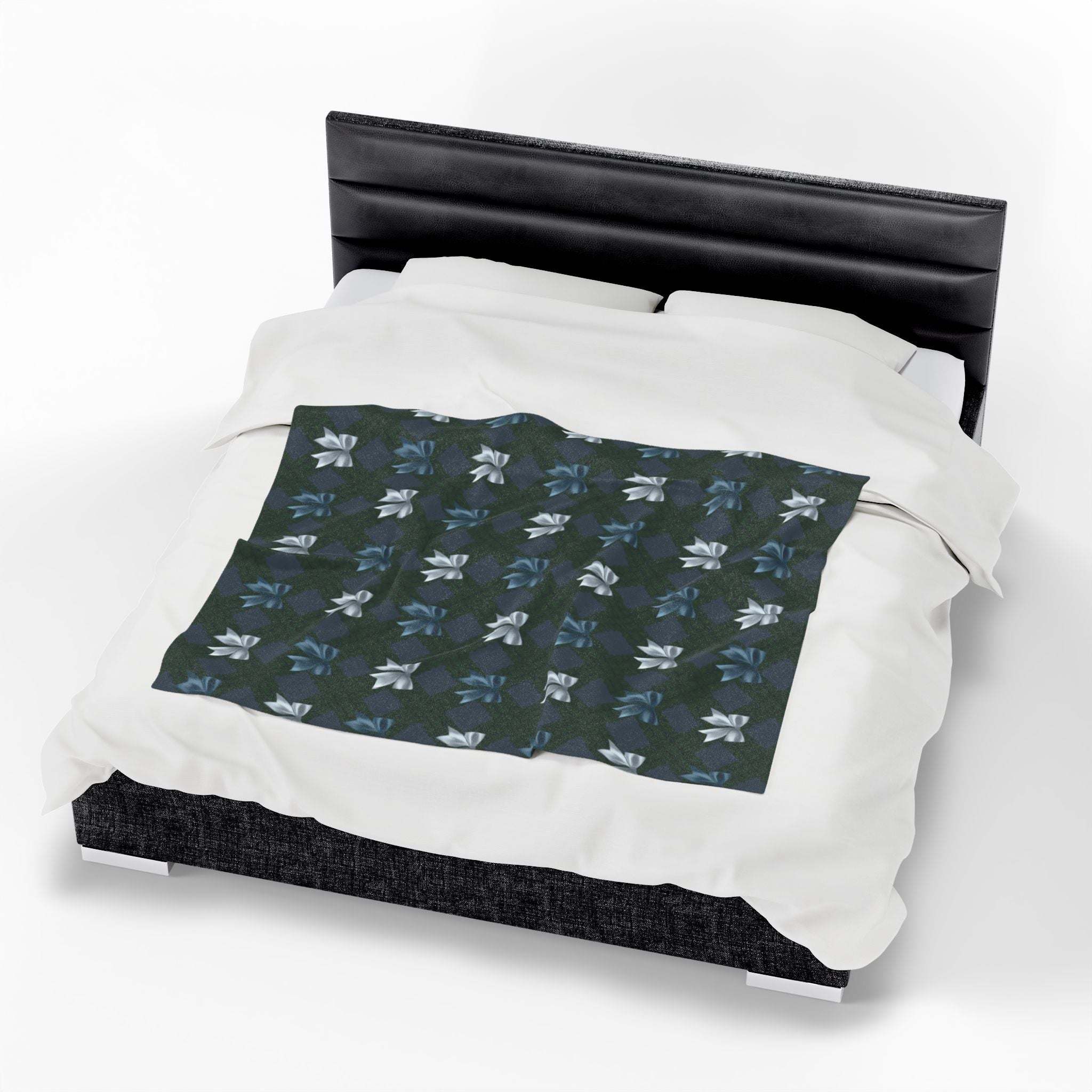 Velveteen plush blanket with Winter Coquette Bows design on bed