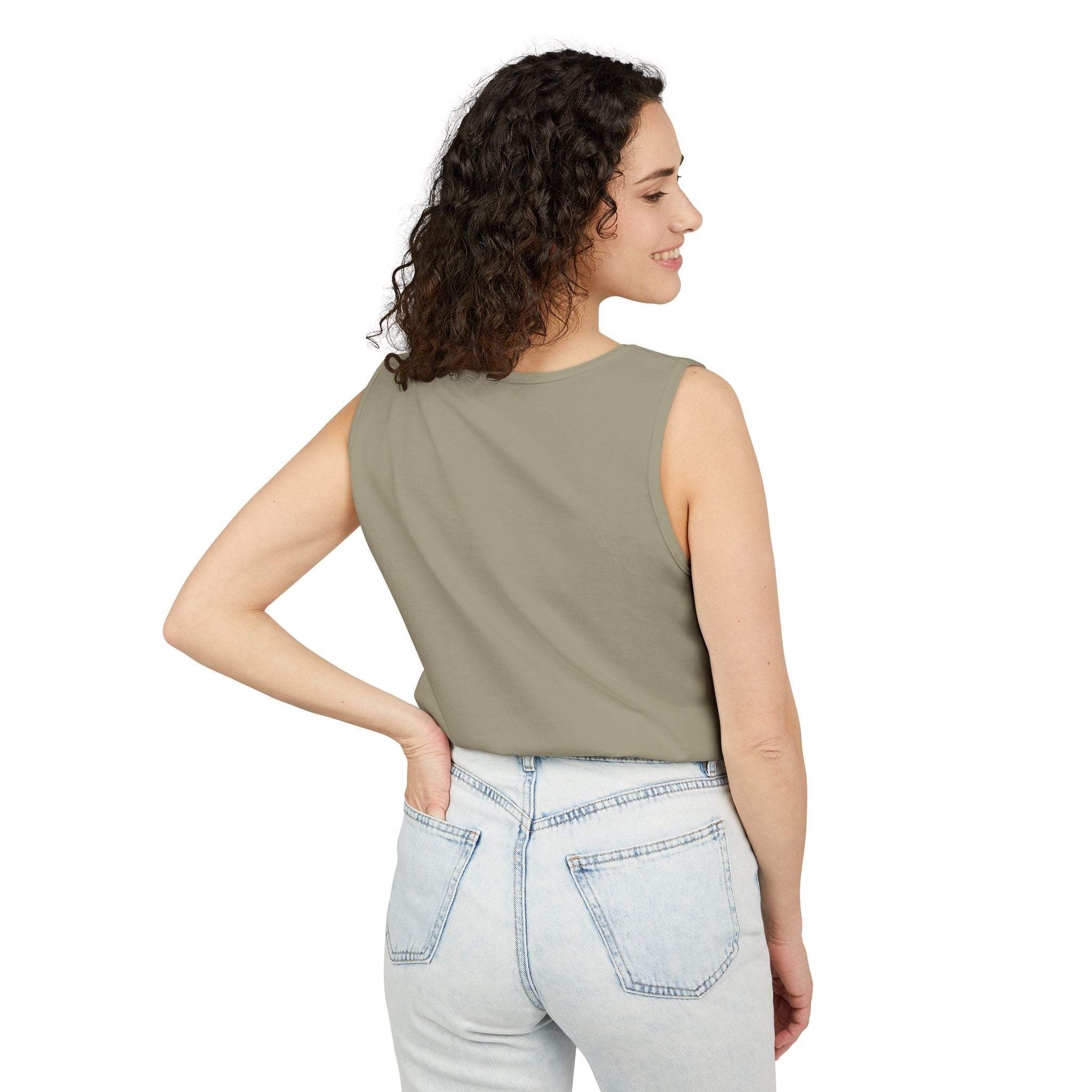 Woman wearing olive green sleeveless tank top with casual fit and light denim jeans back view