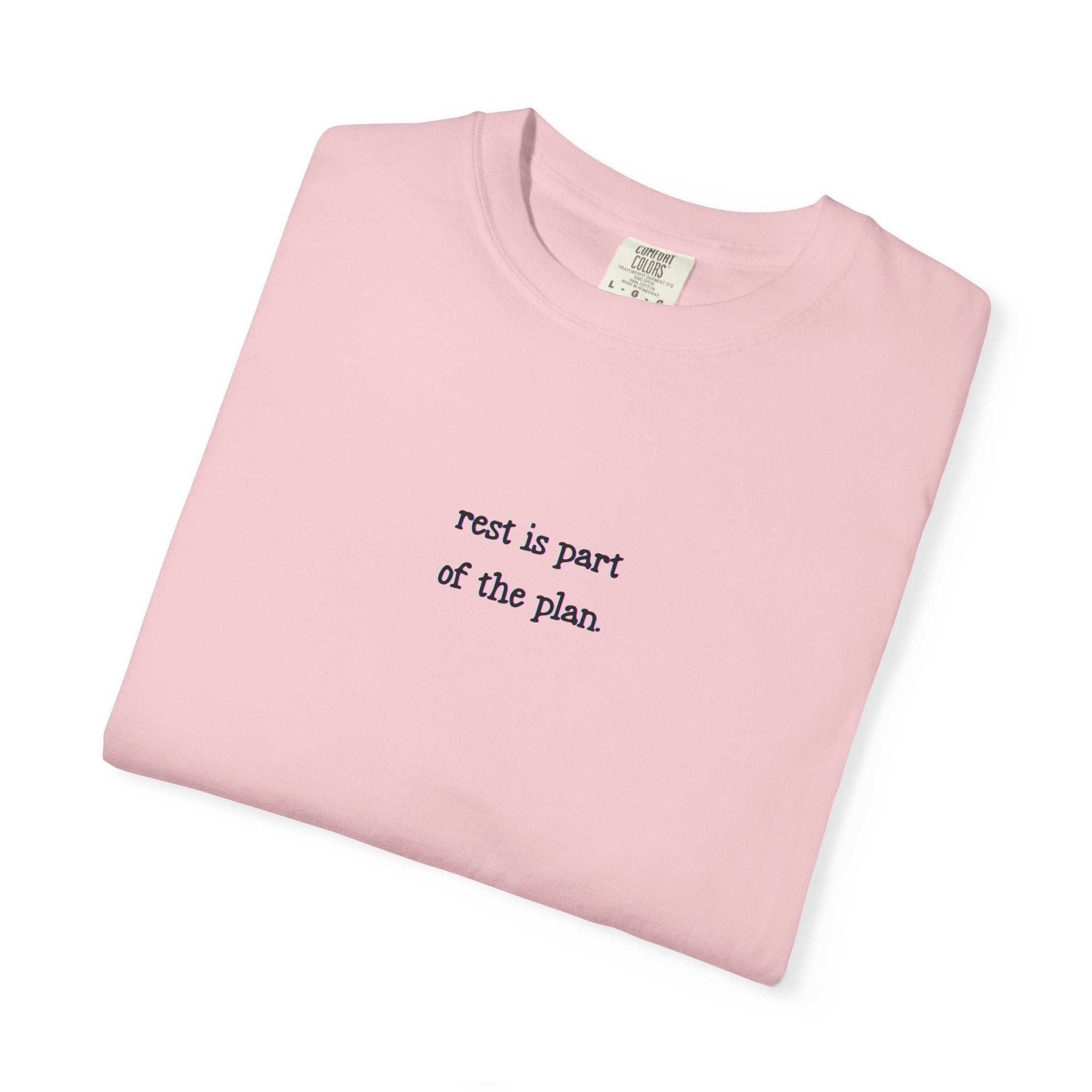 Folded pink t-shirt with text on a white background