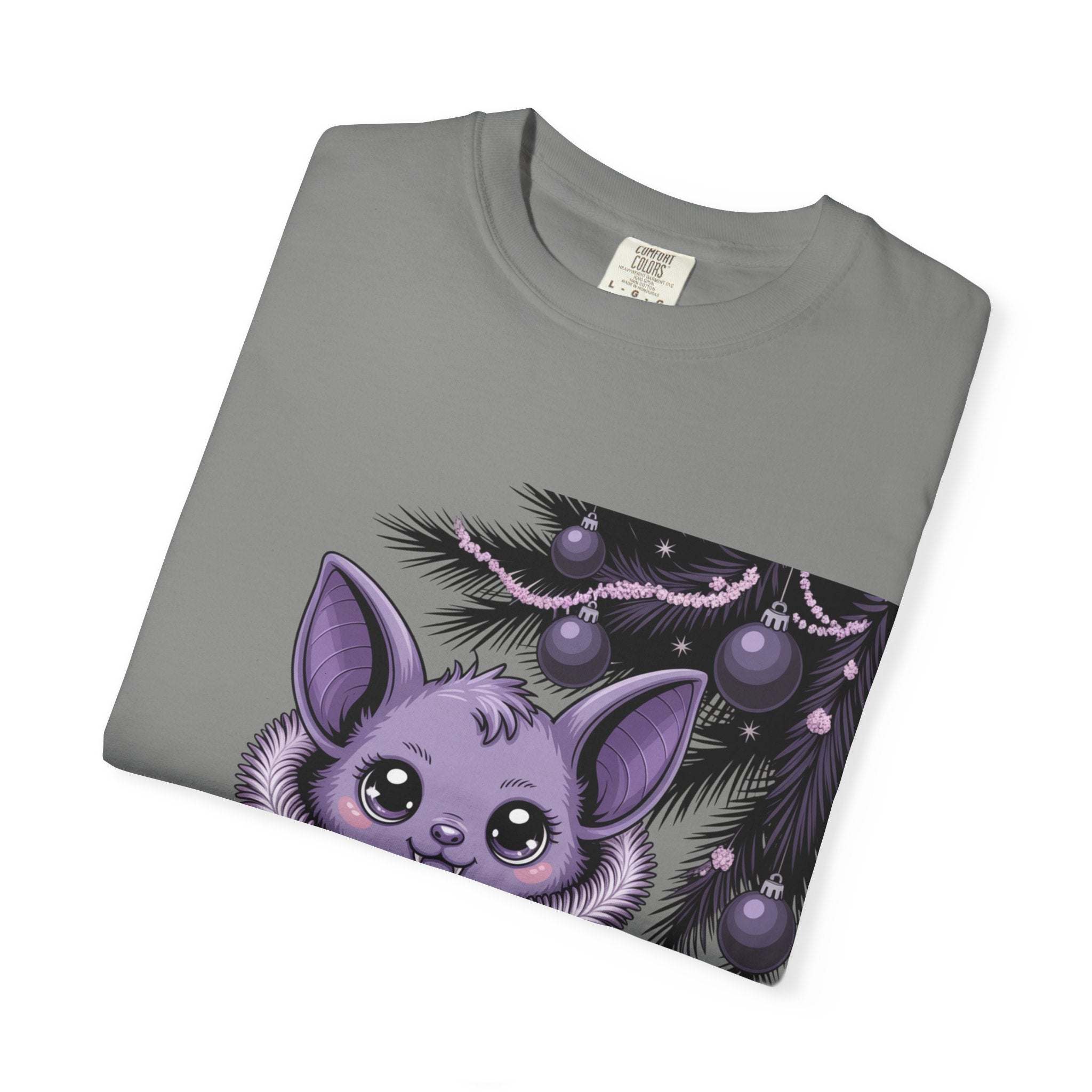 Folded gray t-shirt with a purple bat and Christmas tree design on a white background