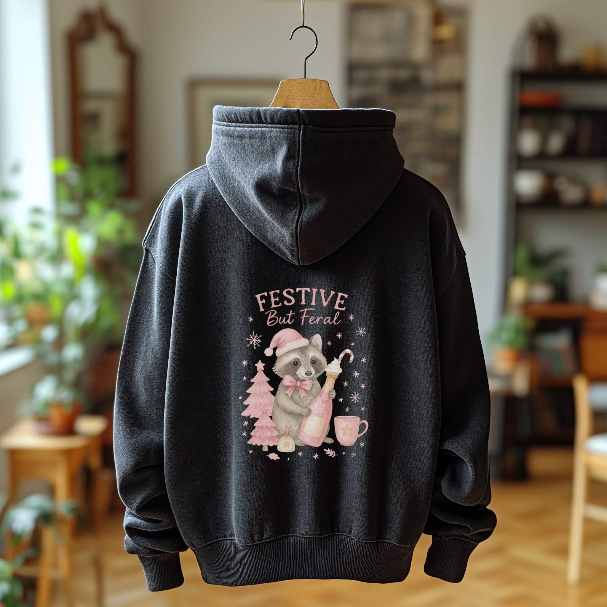 Black fleece hoodie with Festive But Feral raccoon holiday design and adjustable hood