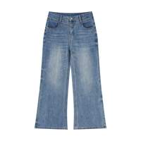 Woman wearing high-rise vintage wash wide leg jeans with loose fit and relaxed silhouette