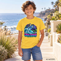 Boy wearing a daisy yellow Local Legend kids T-shirt with a colorful cat and dolphin graphic, paired with denim shorts beside the ocean.