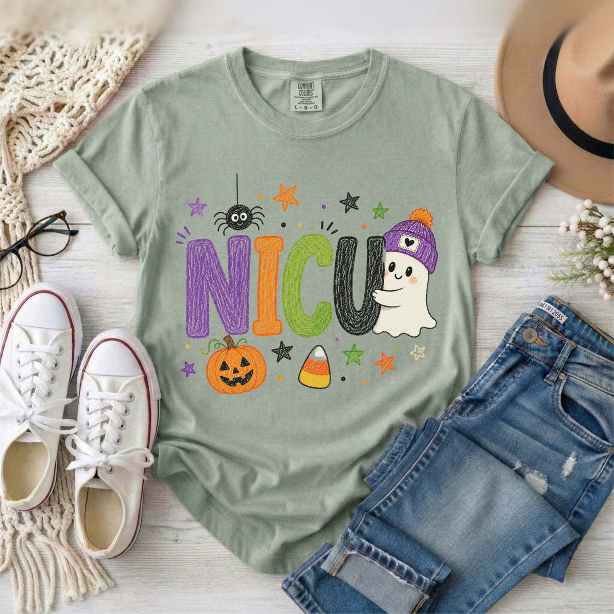Bay green NICU nurse Halloween T-shirt with colorful crayon-style lettering, a smiling ghost in a purple beanie, pumpkin, and candy corn.