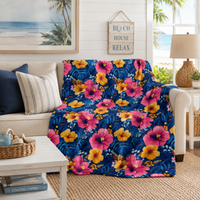 Tropical hibiscus floral velveteen plush blanket with vibrant pink and gold hibiscus on midnight blue background