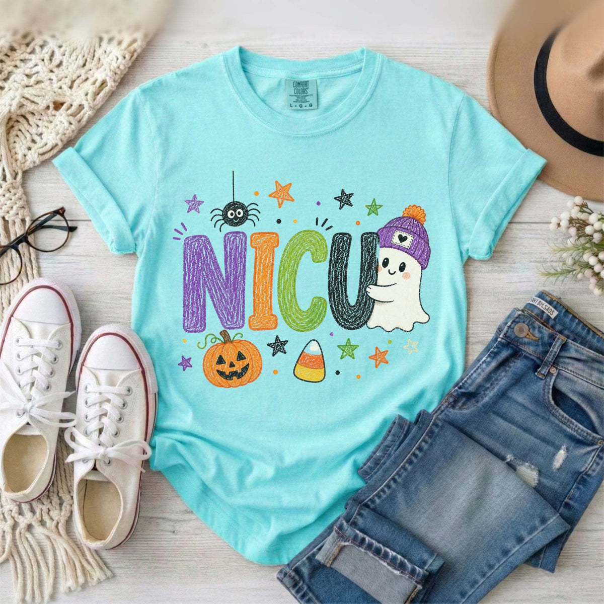 Chalky Mint NICU nurse Halloween T-shirt with colorful crayon-style lettering, a smiling ghost in a purple beanie, pumpkin, and candy corn.