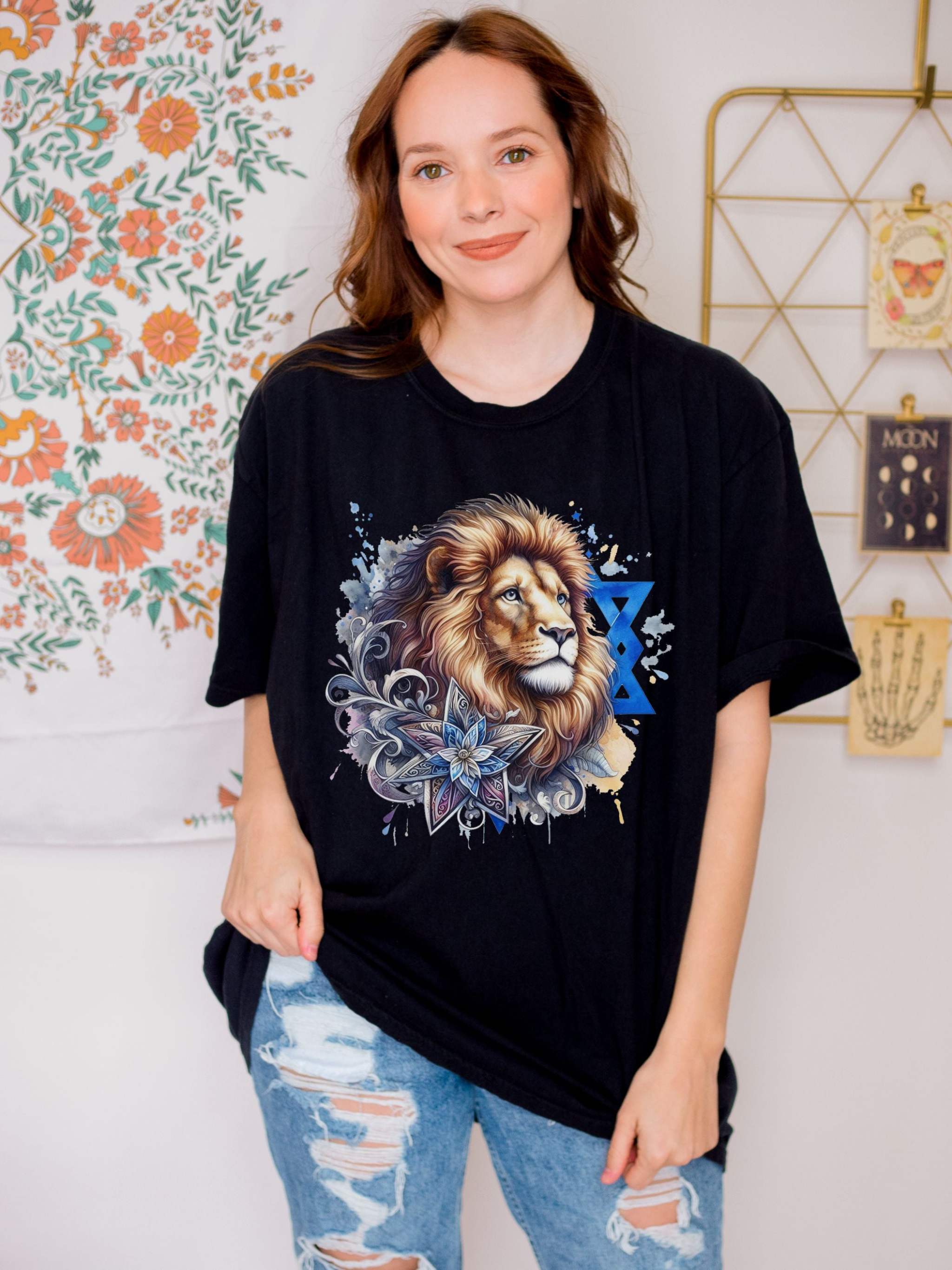 woman wearing black Lion of Judah T-shirt with graphic lion and Star of David design