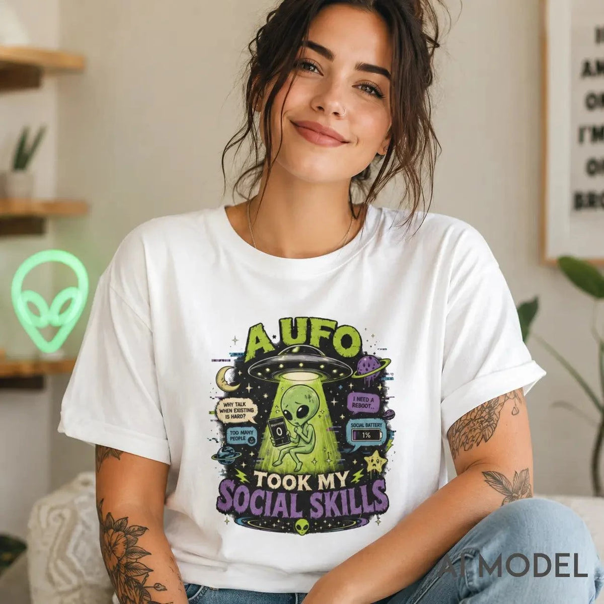 White t-shirt with neon alien and glitchy speech bubbles graphic, caption "UFO Took My Social Skills"