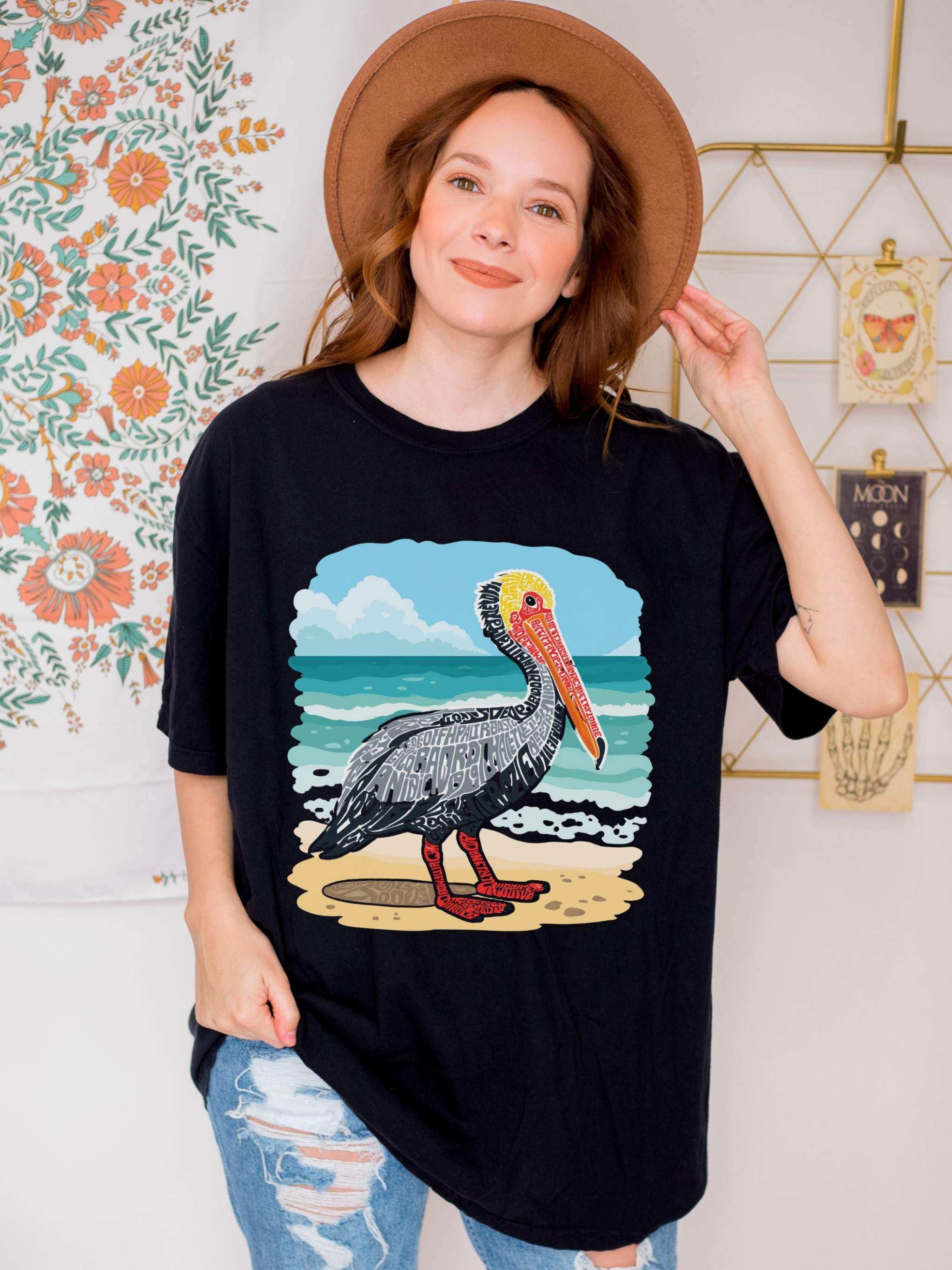 Vintage Pelican Letter Poster graphic on soft coastal tee with washed-in color and relaxed fit