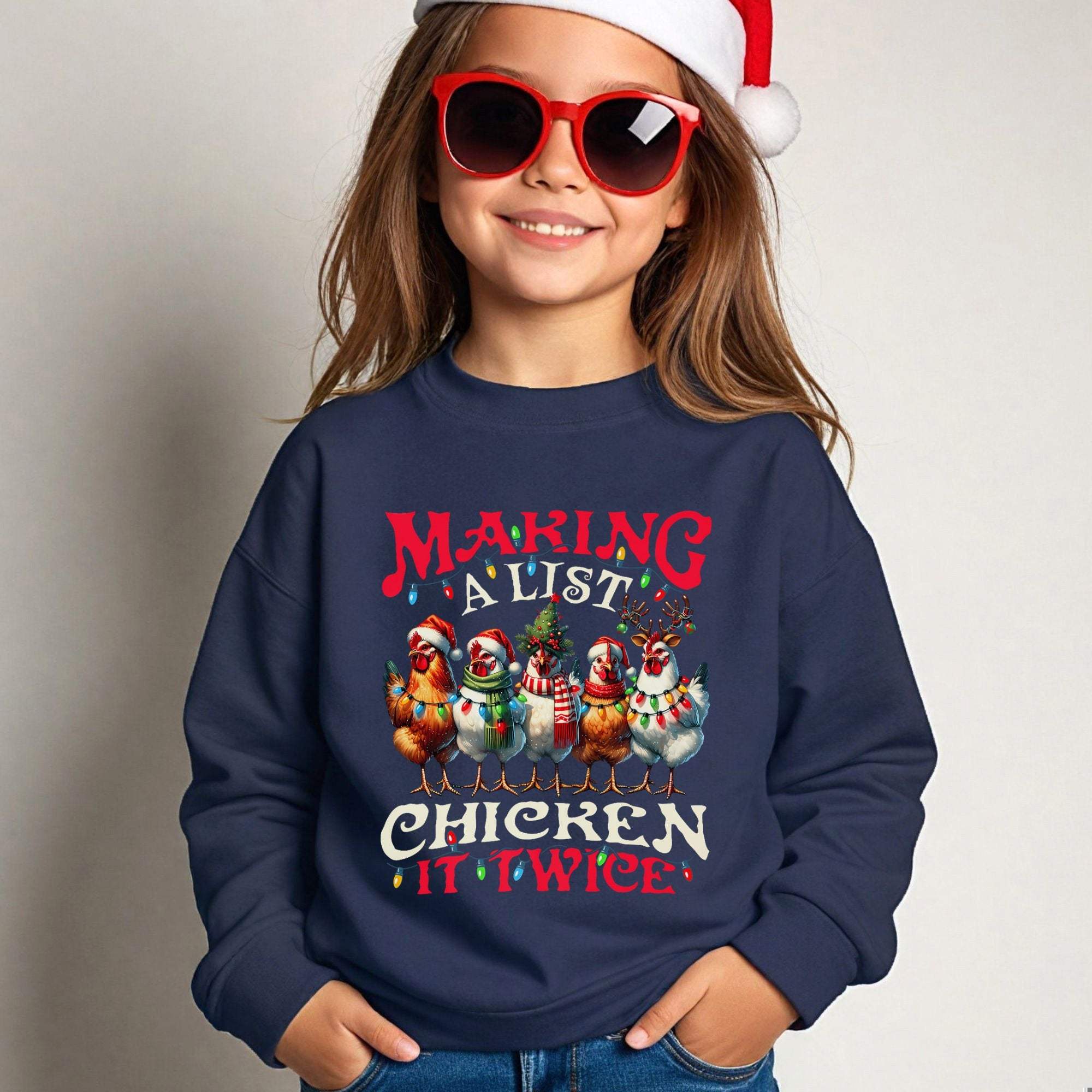 Youth crewneck sweatshirt with festive "Making a List Chicken it Twice" holiday design worn by child in Santa hat and red sunglasses