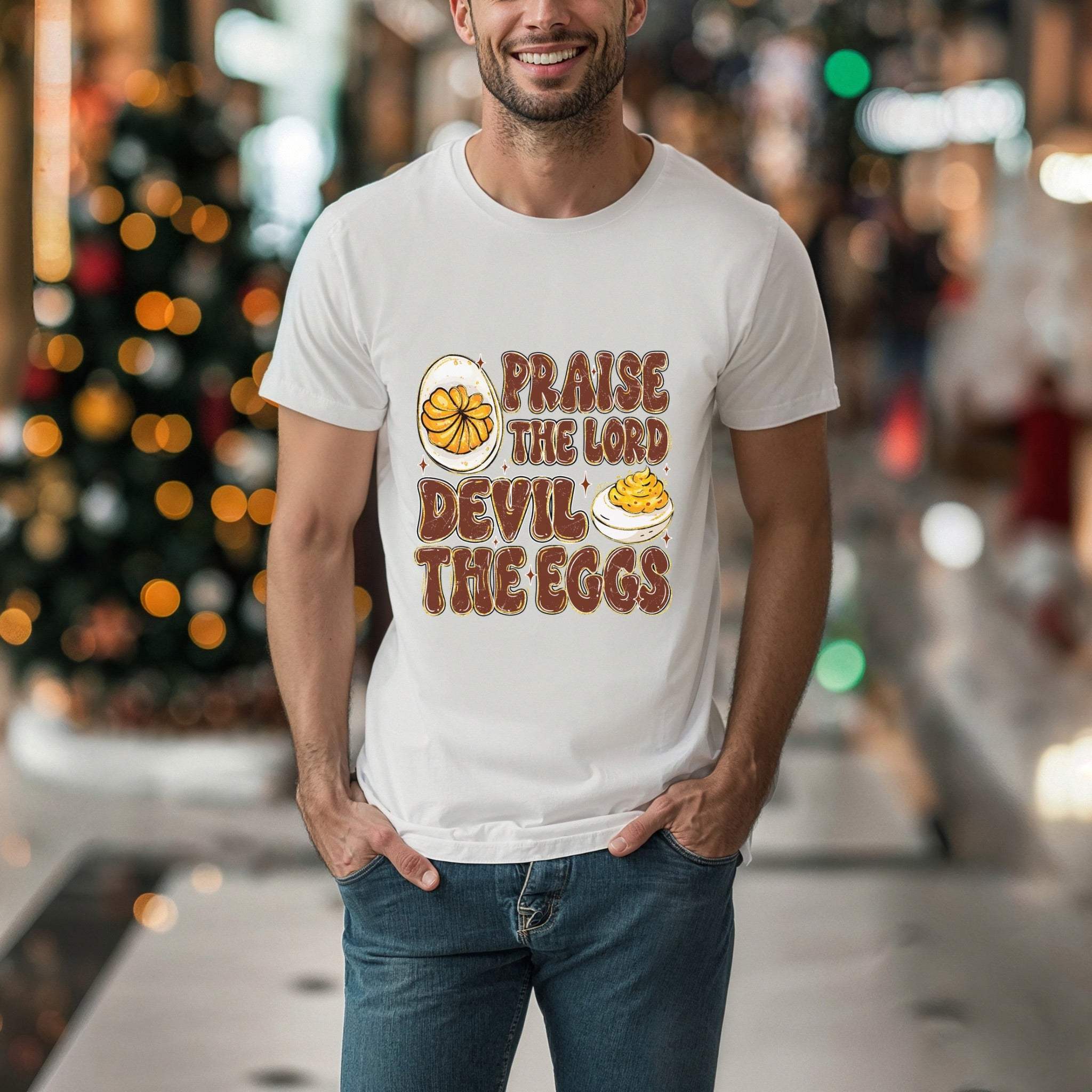 Man wearing white humorous religious unisex T-shirt with Praise the Lord Devil the Eggs design