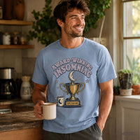 Male model wearing a light blue Award-Winning Insomniac graphic tee featuring a crescent moon, gold trophy and coffee cup while holding a mug.