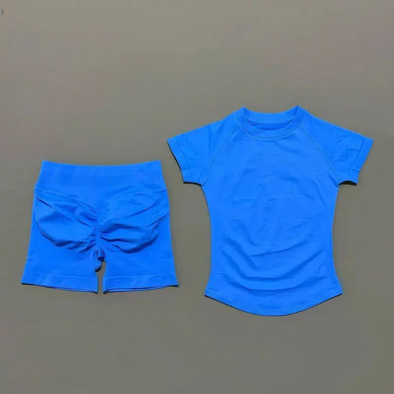 Women wearing Impact Sports Sets seamless yoga tops and high-waist workout shorts in coordinated athletic outfits