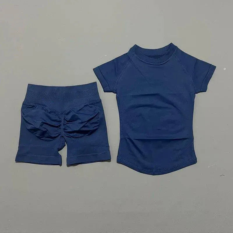 Women wearing Impact Sports Sets seamless yoga top and high-waisted workout shorts in coordinated athletic wear