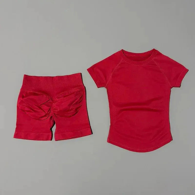 Women wearing Impact Sports Sets seamless yoga top and high-waisted workout shorts