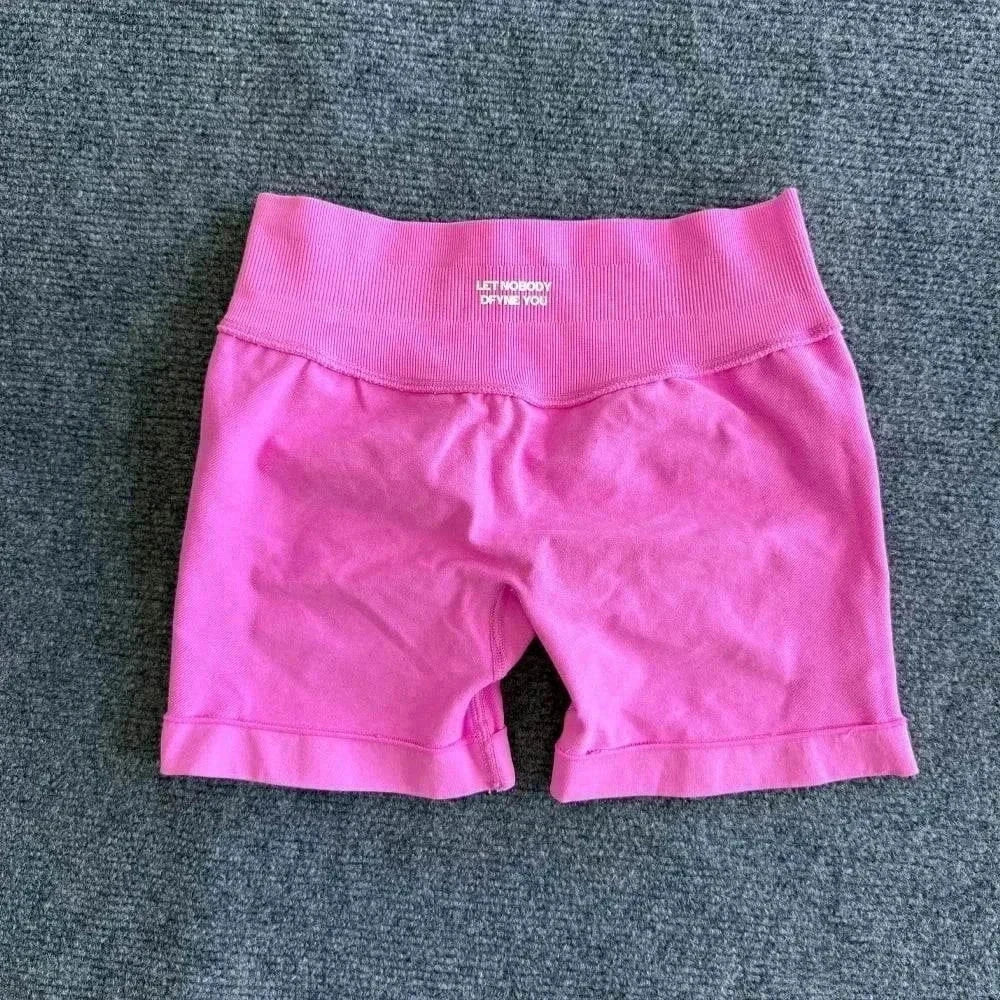 Woman wearing seamless yoga shorts with scrunch bum design and logo for workout and fitness activities