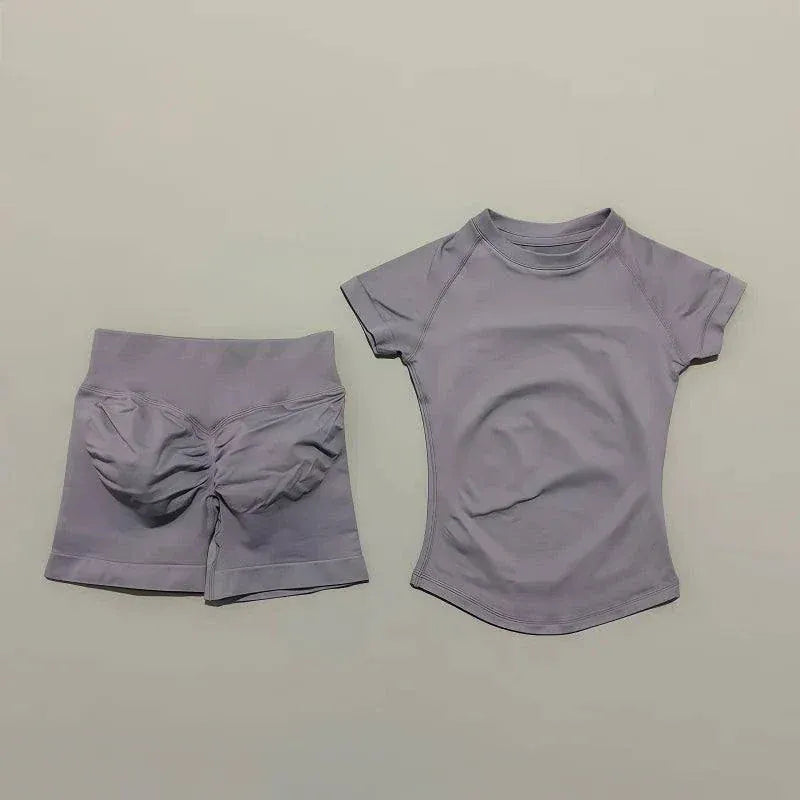 Women wearing Impact Sports Sets seamless yoga top and high-waisted workout shorts in coordinated athletic look