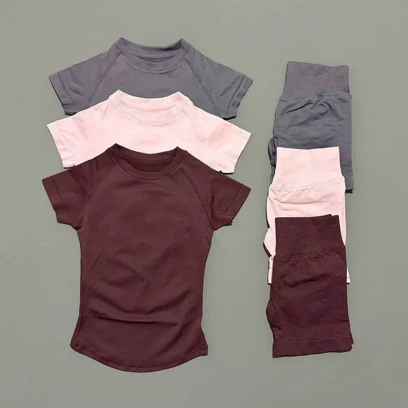 Woman wearing Impact Sports Sets seamless yoga top and workout shorts in active pose