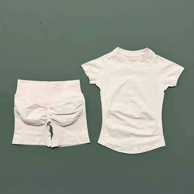 Women wearing sleek seamless yoga tops and high-waisted workout shorts from Impact Sports Sets for fitness and comfort