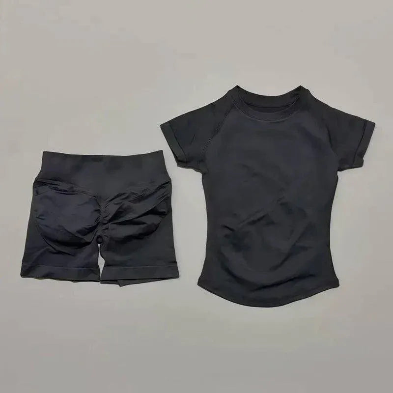 Woman wearing seamless Impact Sports Sets yoga top and high-waisted workout shorts in athletic pose