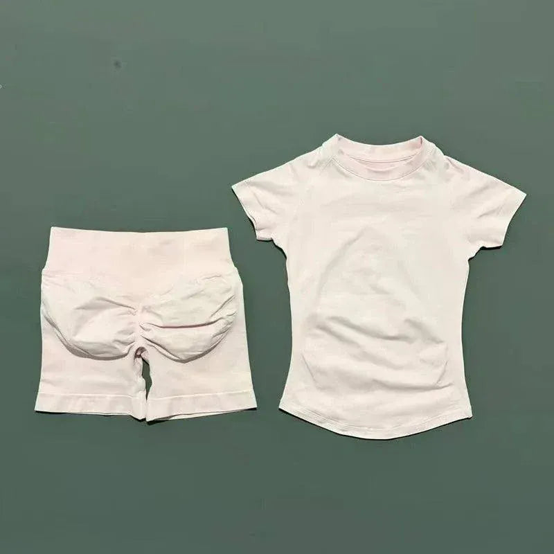 Women wearing Impact Sports Sets seamless yoga top and high-waisted workout shorts in active poses