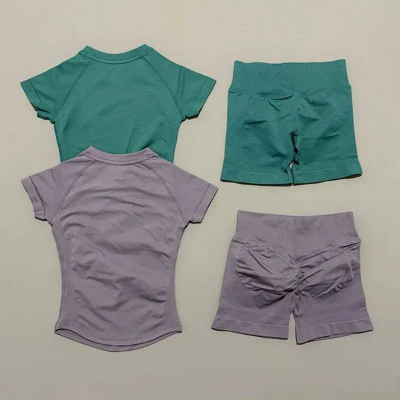 Women wearing Impact Sports Sets seamless yoga top and high-waisted workout shorts for active fitness and yoga sessions