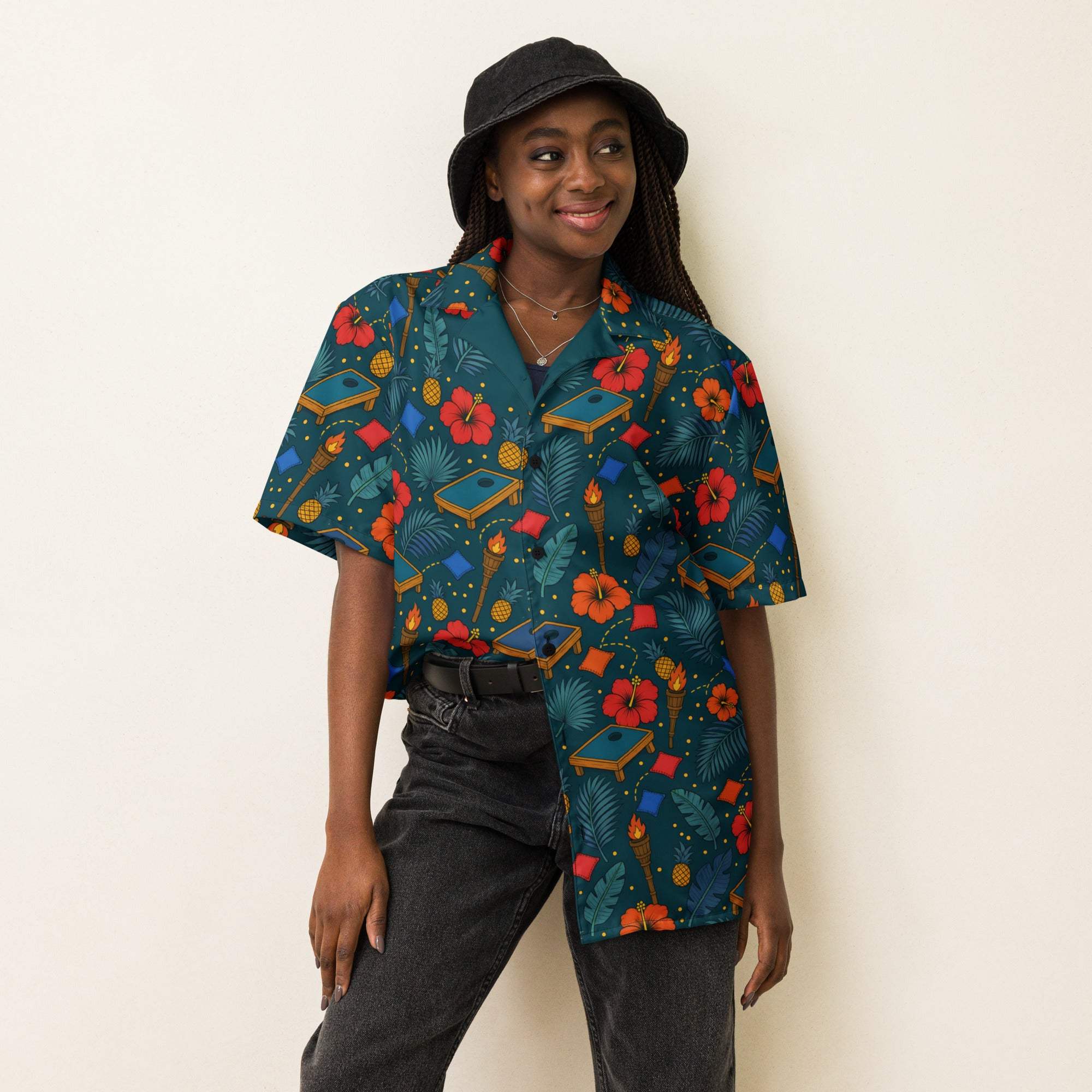 Tropical cornhole Hawaiian shirt with boards, bean bags, tiki torches, and pineapples on deep teal background, unisex UPF 50+ button-up