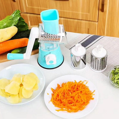 Manual vegetable cutter slicer with hand crank, stainless steel blades, and multiple attachments for slicing vegetables, cheese, and potatoes.