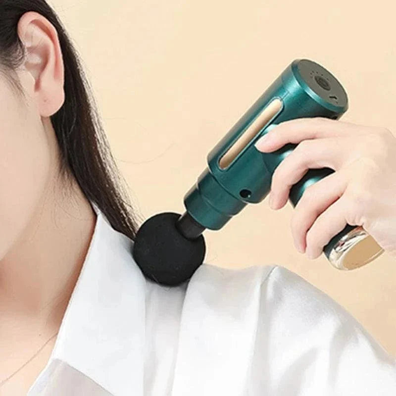 Electric handheld massager gun with vibration therapy for muscle relaxation on shoulder