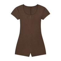 Woman wearing a fitted women’s ribbed tie-waist cape romper with scoop neckline and short sleeves