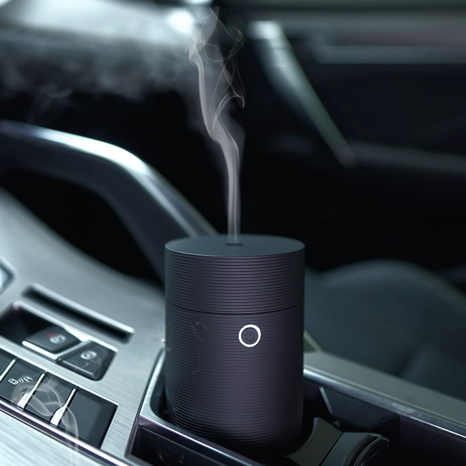 USB car humidifier releasing cool mist inside a vehicle cup holder connected via USB port