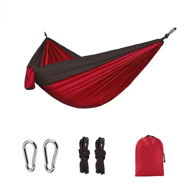 Single person portable outdoor camping hammock in red and black nylon with hanging accessories and storage bag