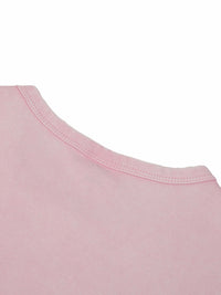 Woman wearing a snow washed crop top with round neck and drop shoulder sleeves in casual streetwear style