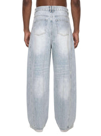 Men's vintage wash sunfade barrel leg jeans with frayed details and relaxed fit on model