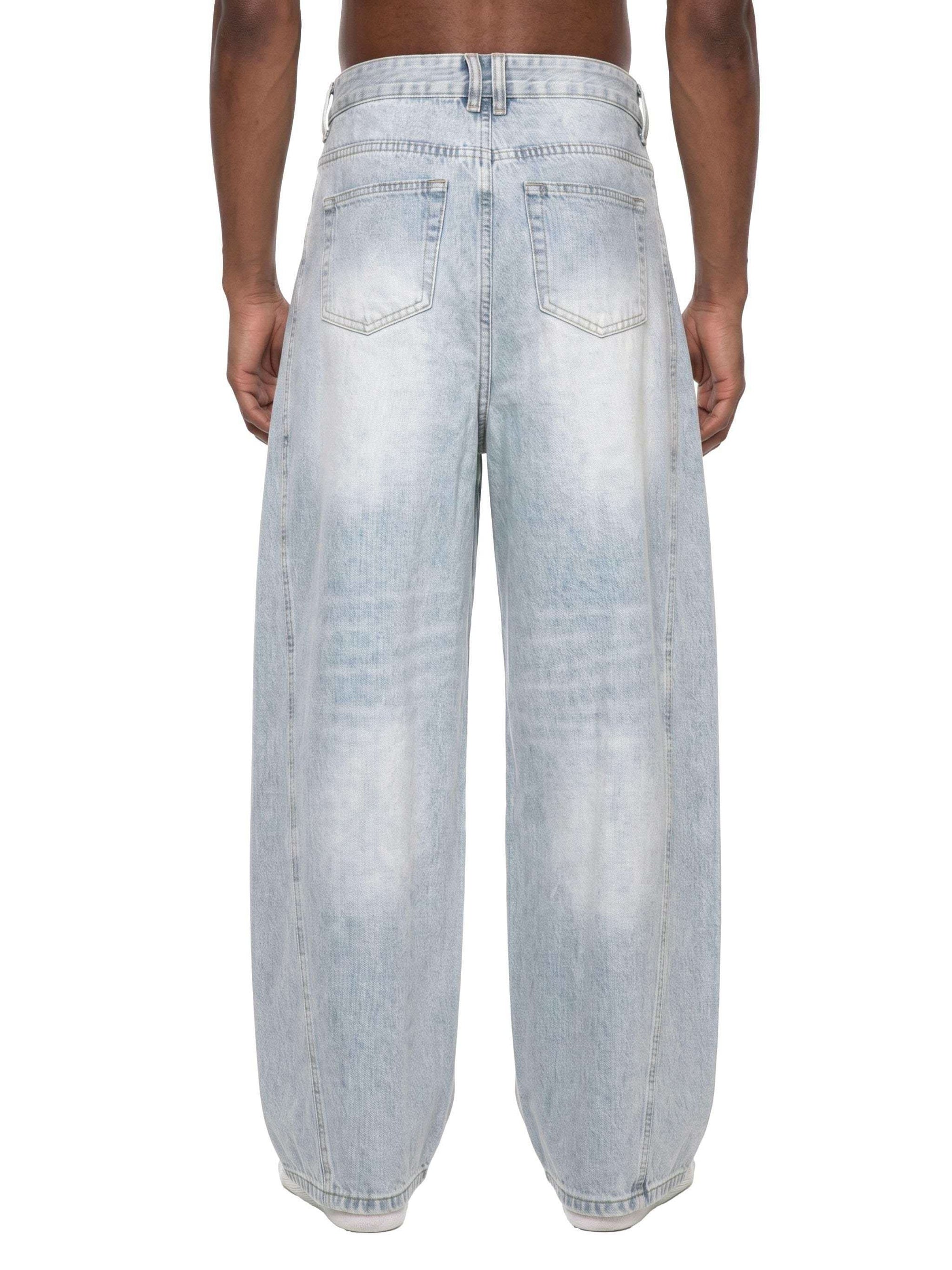 Men's vintage wash sunfade barrel leg jeans with frayed details and relaxed fit on model
